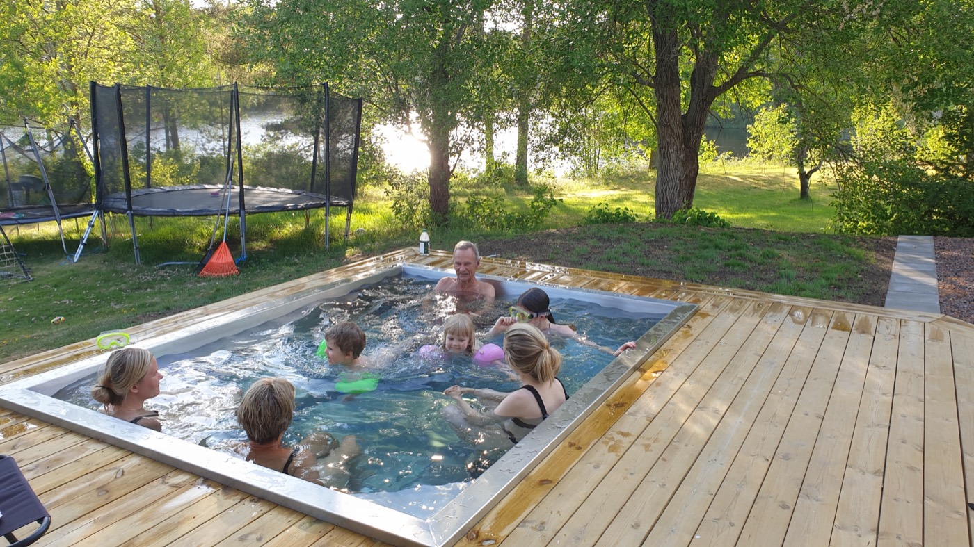 Children in a rectangular stainless steel garden pool
