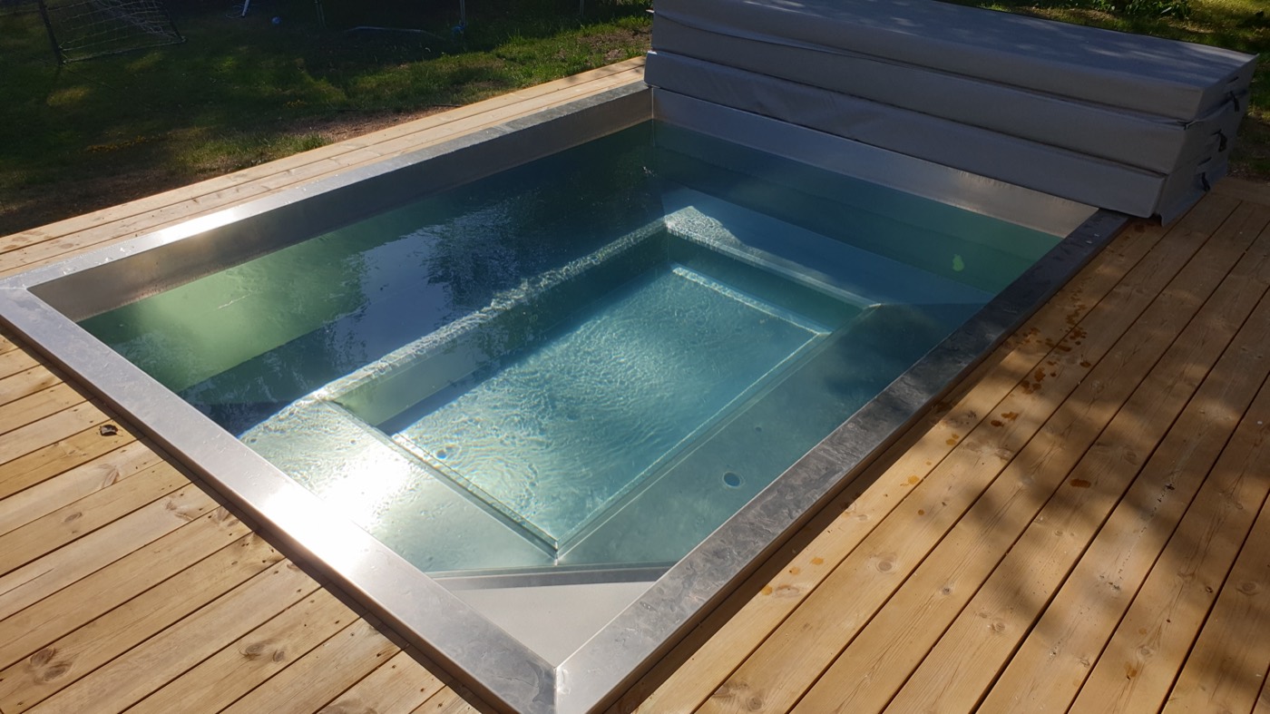 Rectangular stainless steel spa bath on a garden deck